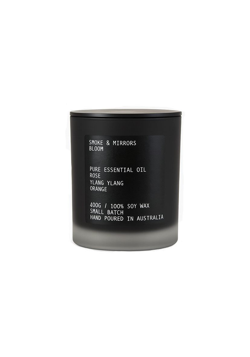 Black candle with white text on a white background