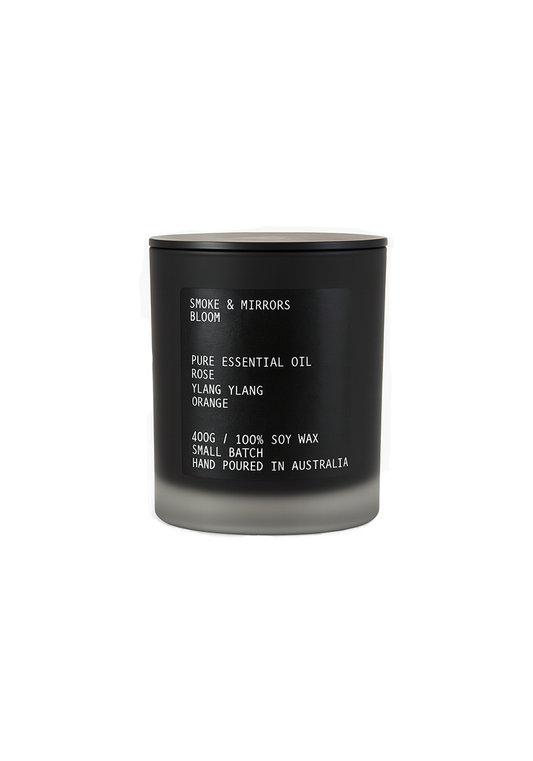 Black candle with white text on a white background